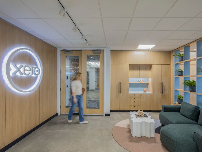 A Xero team member walks through a workspace in the company’s office